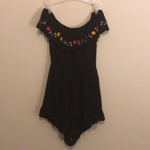 Black off the shoulder romper with floral design.